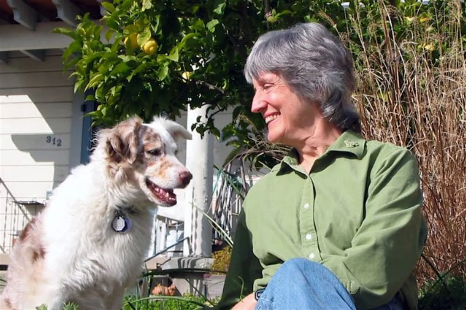 Donna Haraway seated with her dog Cayenne Pepper.