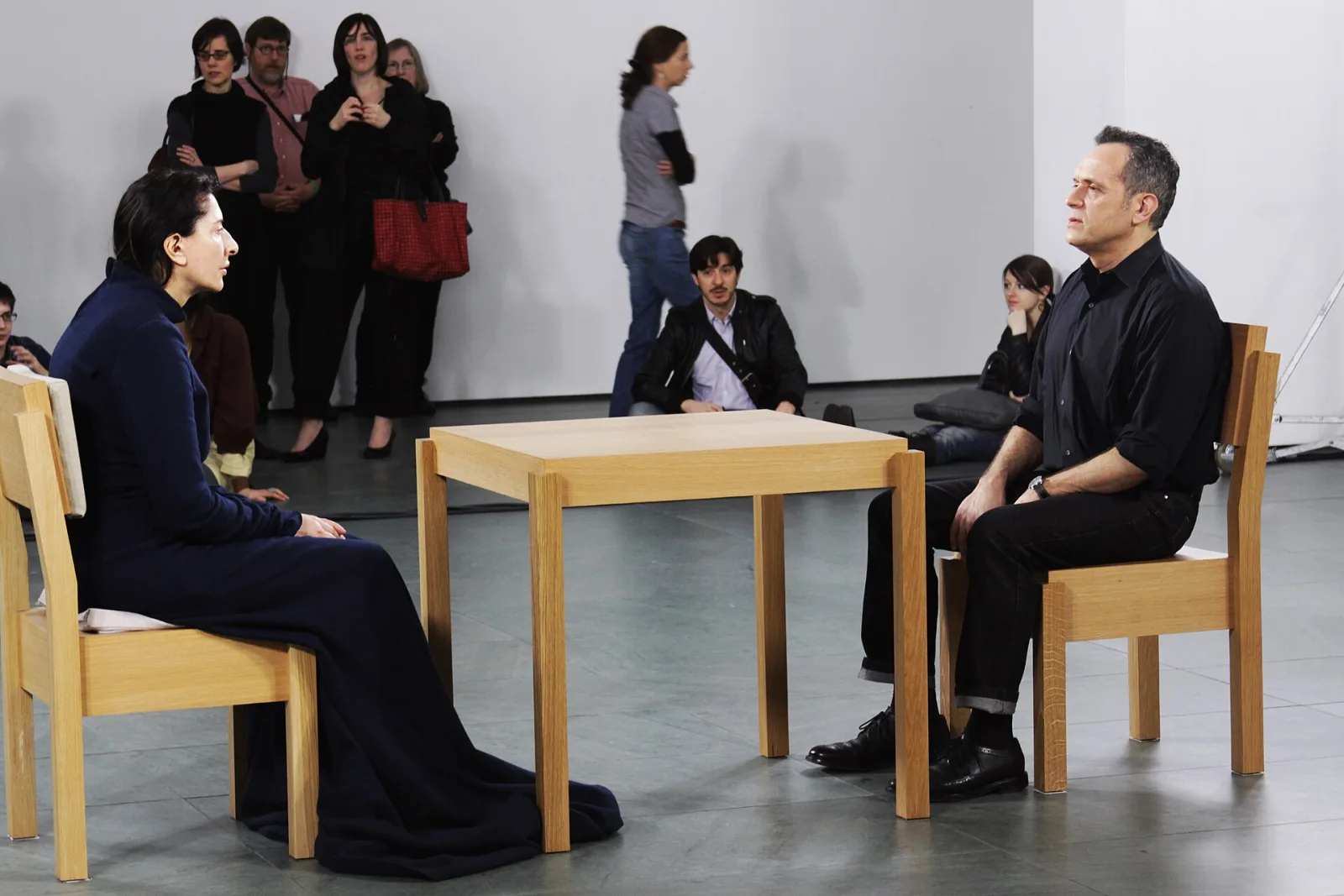 Marina Abramovic seated across from a museum visitor during The Artist Is Present.